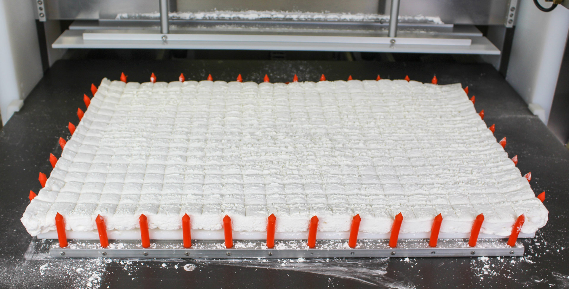 Sheet of white gourmet marshmallows sliced on the CS-10TWWA cutting machine.